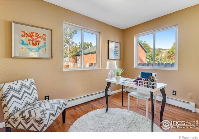 217 Park St, Lyons, CO 80540 - office space with a baseboard heating unit, wood finished floors, and baseboards