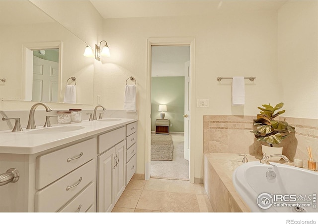 full bathroom featuring tile patterned flooring, double vanity, a garden tub, and a sink