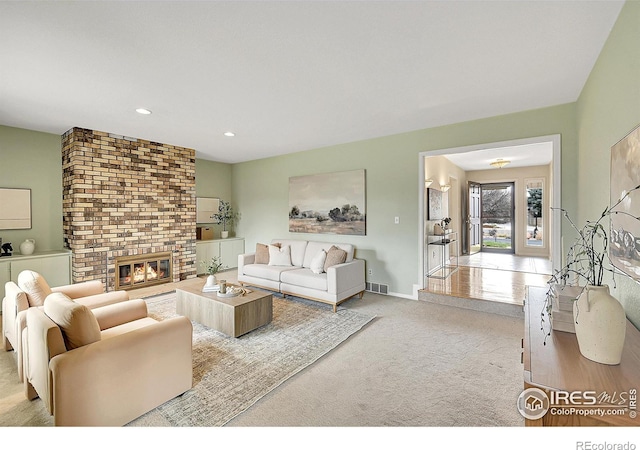 living area featuring baseboards, recessed lighting, a fireplace, carpet flooring, and visible vents