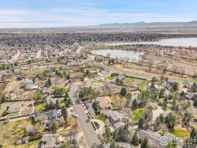 drone / aerial view with a residential view and a water and mountain view