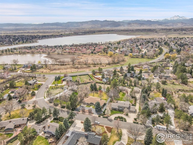 aerial view with a water and mountain view and a residential view