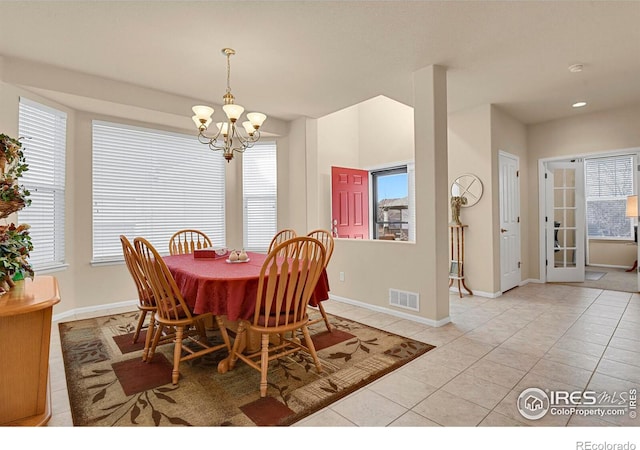 dining room featuring a chandelier, plenty of natural light, visible vents, and light tile patterned flooring