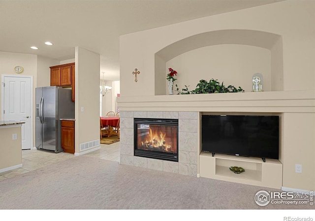living area with visible vents, light tile patterned floors, a fireplace, recessed lighting, and light carpet
