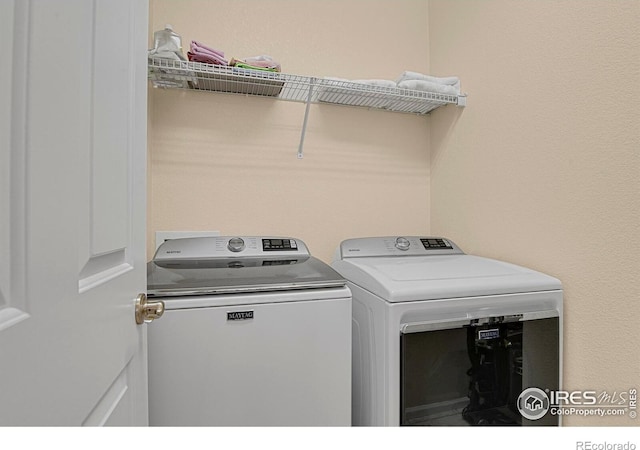 washroom featuring laundry area and washing machine and clothes dryer