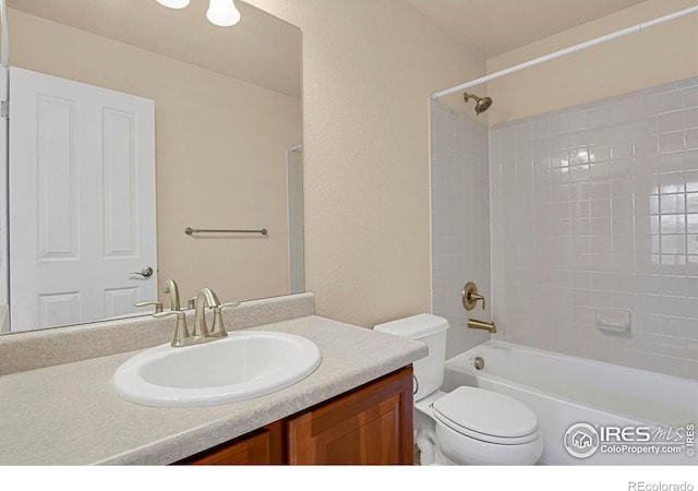 bathroom featuring toilet, shower / bath combination, and vanity