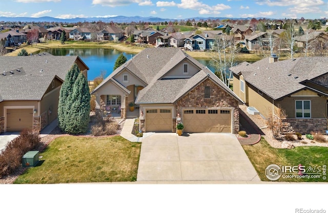 6741 Bandon Dunes Dr, Windsor, CO 80550 - craftsman house with concrete driveway, a residential view, stone siding, and a garage