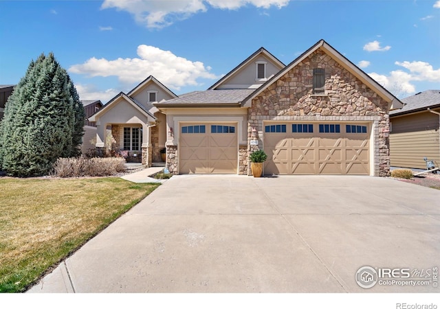 6741 Bandon Dunes Dr, Windsor, CO 80550 - view of front facade featuring concrete driveway, stucco siding, stone siding, a front yard, and a garage