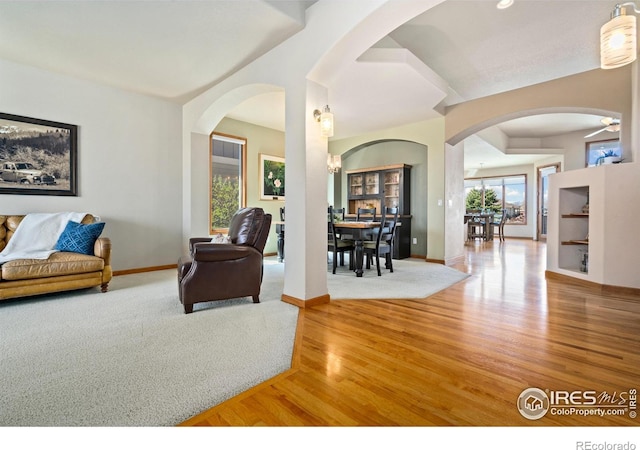 6741 Bandon Dunes Dr, Windsor, CO 80550 - interior space with arched walkways, wood finished floors, and baseboards