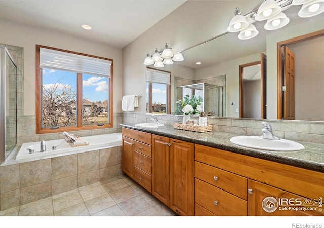 6741 Bandon Dunes Dr, Windsor, CO 80550 - full bathroom featuring a sink, tile patterned floors, a shower stall, and a garden tub