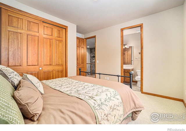 6741 Bandon Dunes Dr, Windsor, CO 80550 - carpeted bedroom featuring a closet, baseboards, and ensuite bath