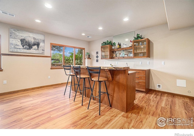 6741 Bandon Dunes Dr, Windsor, CO 80550 - bar with visible vents, light wood-type flooring, recessed lighting, and indoor wet bar