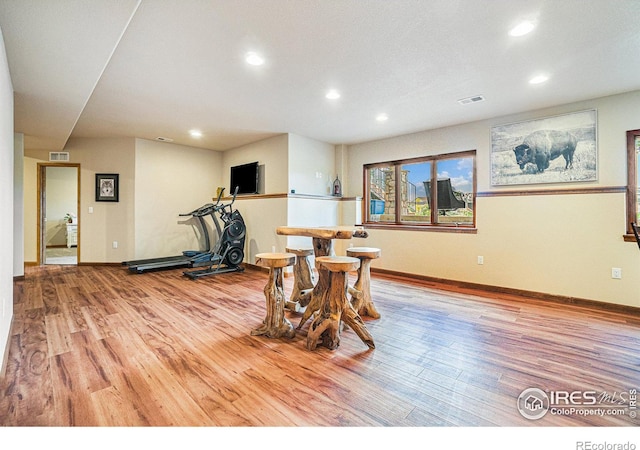 6741 Bandon Dunes Dr, Windsor, CO 80550 - workout area featuring wood finished floors, baseboards, visible vents, and recessed lighting