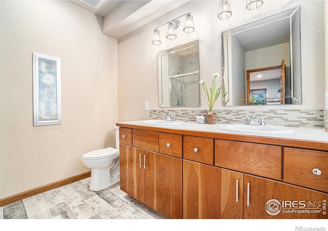 6741 Bandon Dunes Dr, Windsor, CO 80550 - bathroom with a sink, backsplash, and a shower stall