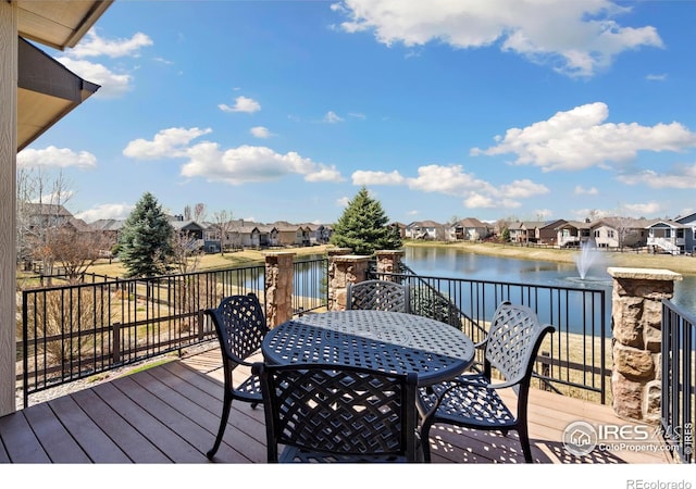 6741 Bandon Dunes Dr, Windsor, CO 80550 - deck with outdoor dining space, a residential view, and a water view