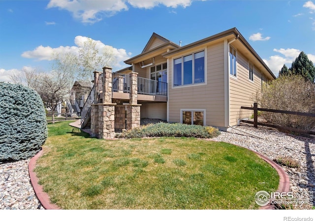 6741 Bandon Dunes Dr, Windsor, CO 80550 - back of house featuring a yard, a deck, and stairs