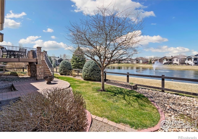 6741 Bandon Dunes Dr, Windsor, CO 80550 - view of yard with a water view, stairs, and a residential view