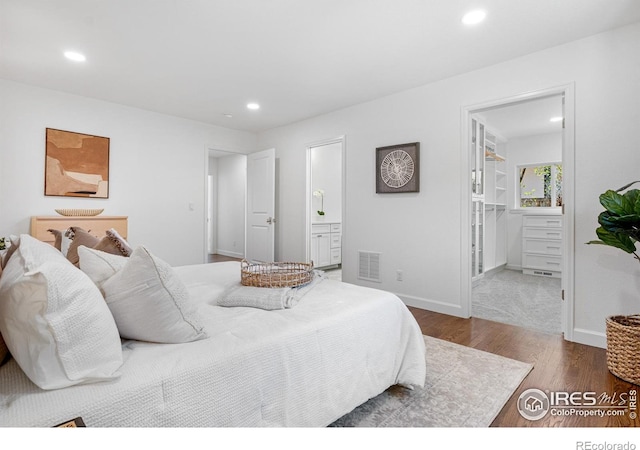 545 S Harrison Ln, Denver, CO 80209 - bedroom featuring visible vents, wood finished floors, baseboards, recessed lighting, and ensuite bath