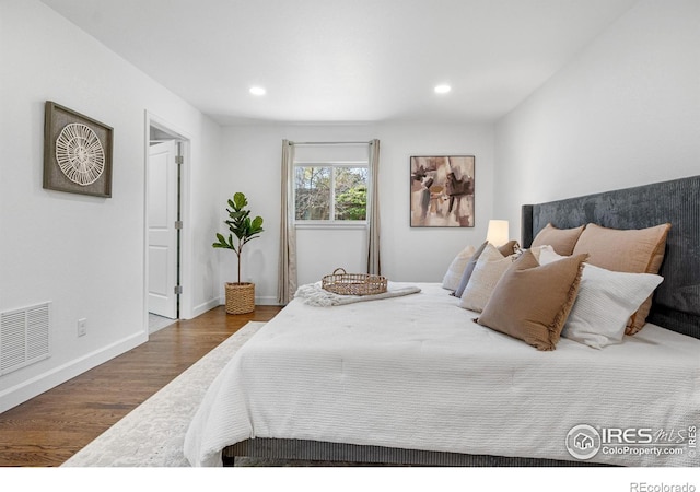 545 S Harrison Ln, Denver, CO 80209 - bedroom with baseboards, recessed lighting, wood finished floors, and visible vents