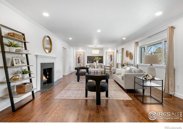 545 S Harrison Ln, Denver, CO 80209 - living room featuring ornamental molding, baseboards, a warm lit fireplace, dark wood-type flooring, and recessed lighting