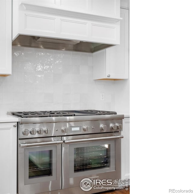 545 S Harrison Ln, Denver, CO 80209 - kitchen featuring backsplash, white cabinetry, double oven range, and premium range hood