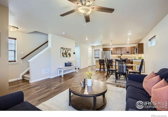 61 Avocet Ct, Longmont, CO 80501 - living room with wood finished floors, stairs, plenty of natural light, and baseboards