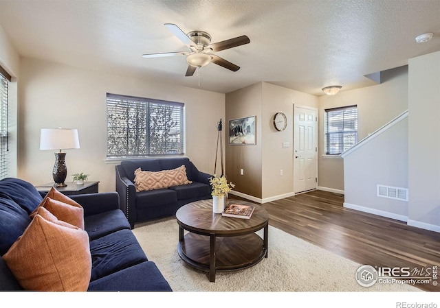 61 Avocet Ct, Longmont, CO 80501 - living room with wood finished floors, a ceiling fan, baseboards, and stairway
