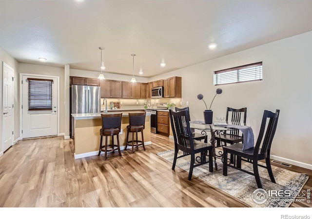 61 Avocet Ct, Longmont, CO 80501 - dining area with light wood-type flooring, baseboards, and recessed lighting