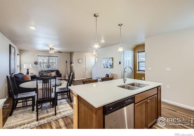 61 Avocet Ct, Longmont, CO 80501 - kitchen featuring dishwasher, a sink, open floor plan, wood finished floors, and a ceiling fan