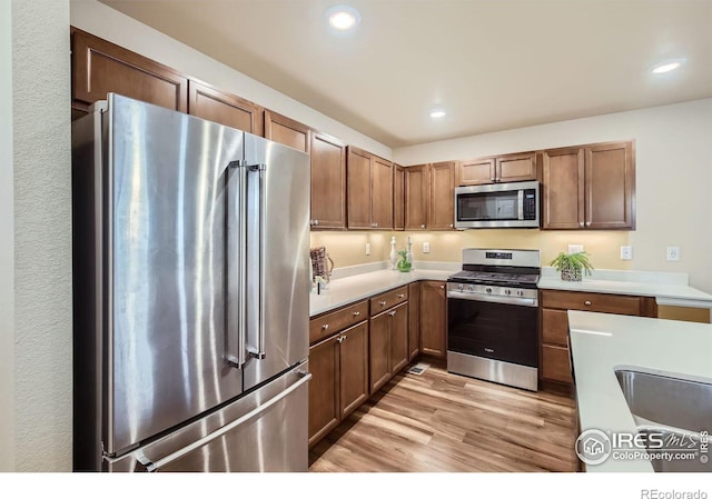 61 Avocet Ct, Longmont, CO 80501 - kitchen with stainless steel appliances, light wood-style floors, light countertops, and recessed lighting