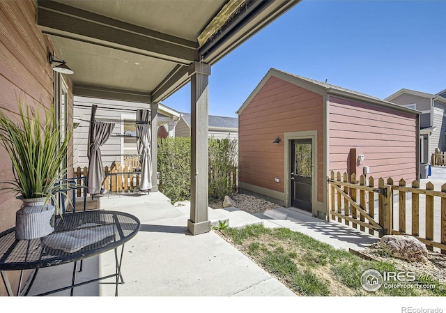 61 Avocet Ct, Longmont, CO 80501 - view of patio / terrace featuring fence and an outbuilding