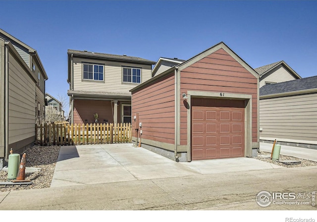 61 Avocet Ct, Longmont, CO 80501 - view of front facade with fence, an attached garage, and an outdoor structure