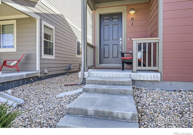 61 Avocet Ct, Longmont, CO 80501 - doorway to property with a porch