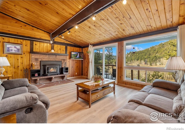 712 Aspen Dr, Lyons, CO 80540 - living room with lofted ceiling with beams, rail lighting, wooden ceiling, wood walls, and wood finished floors