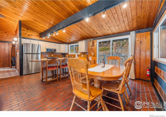712 Aspen Dr, Lyons, CO 80540 - dining area featuring wooden walls, brick floor, and wooden ceiling