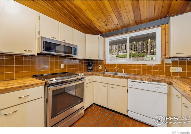 712 Aspen Dr, Lyons, CO 80540 - kitchen featuring tasteful backsplash, wooden ceiling, a sink, appliances with stainless steel finishes, and white cabinetry