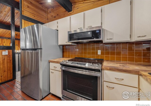 712 Aspen Dr, Lyons, CO 80540 - kitchen featuring butcher block counters, backsplash, white cabinetry, and stainless steel appliances