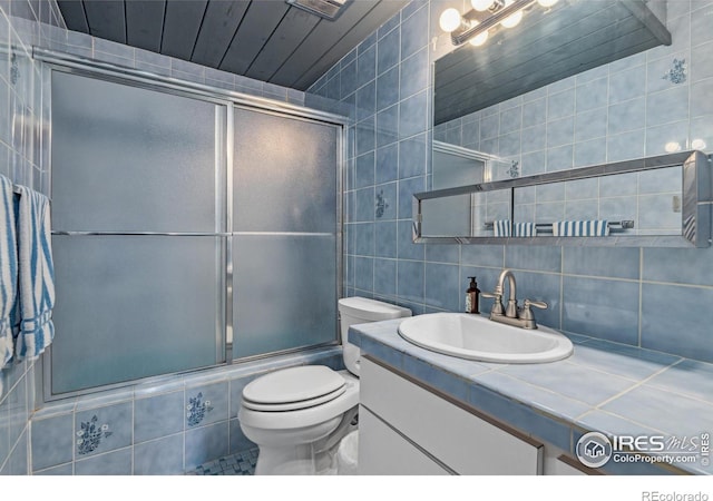 712 Aspen Dr, Lyons, CO 80540 - full bathroom featuring tasteful backsplash, vanity, toilet, tile walls, and tiled shower / bath
