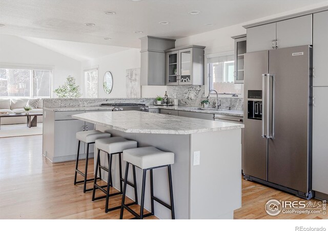 1835 Columbine Ave, Boulder, CO 80302 - kitchen with a peninsula, high end fridge, a sink, gray cabinets, and decorative backsplash