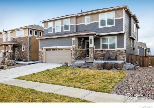 9283 Sedalia St, Commerce City, CO 80022 - view of front facade with a front yard, driveway, stone siding, and an attached garage