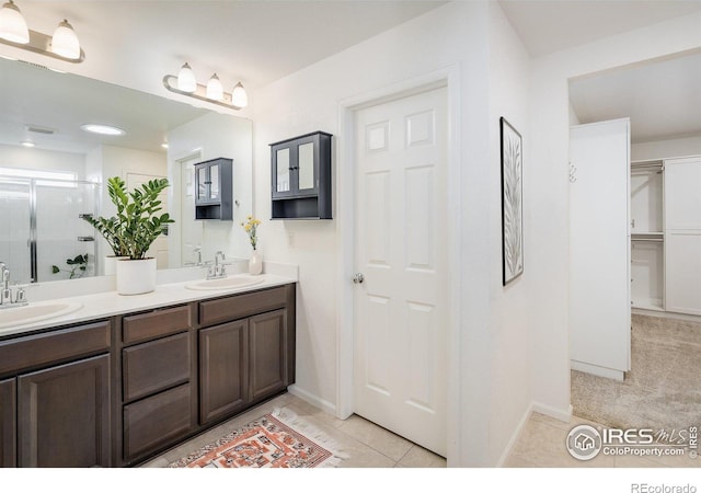 9283 Sedalia St, Commerce City, CO 80022 - full bath with a shower stall, tile patterned floors, double vanity, and a sink