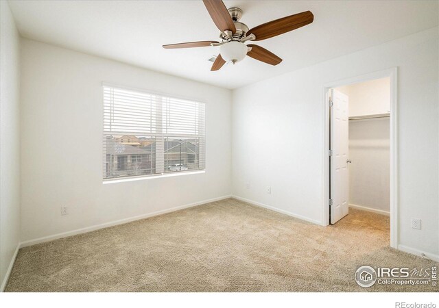 9283 Sedalia St, Commerce City, CO 80022 - unfurnished bedroom featuring ceiling fan, carpet, a closet, a walk in closet, and baseboards
