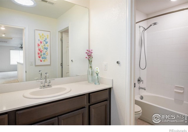 9283 Sedalia St, Commerce City, CO 80022 - bathroom featuring vanity, visible vents, toilet, and shower / washtub combination