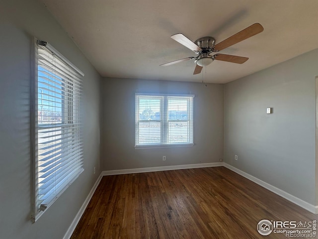 empty room with baseboards, ceiling fan, and wood finished floors