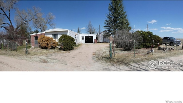 317 N Ord St, Grover, CO 80729 - view of front of house with an attached garage, fence, and driveway