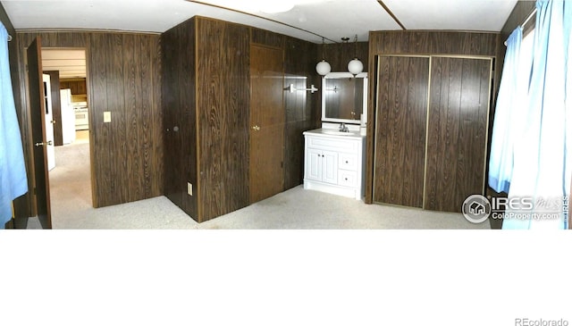 317 N Ord St, Grover, CO 80729 - bedroom featuring wooden walls, a closet, carpet, and a sink
