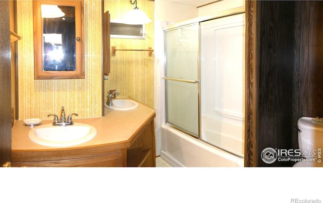 317 N Ord St, Grover, CO 80729 - full bath featuring a sink, toilet, double vanity, and enclosed tub / shower combo