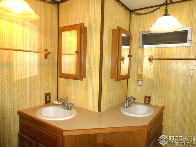 317 N Ord St, Grover, CO 80729 - bathroom with wallpapered walls, double vanity, and a sink