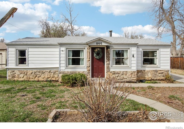800 W 10th St, Loveland, CO 80537 - view of front facade with stone siding and fence