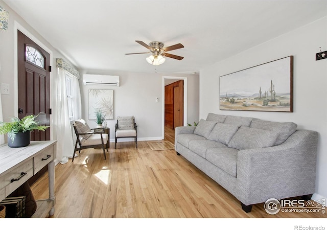 800 W 10th St, Loveland, CO 80537 - living area featuring light wood-type flooring, a wall unit AC, ceiling fan, and baseboards