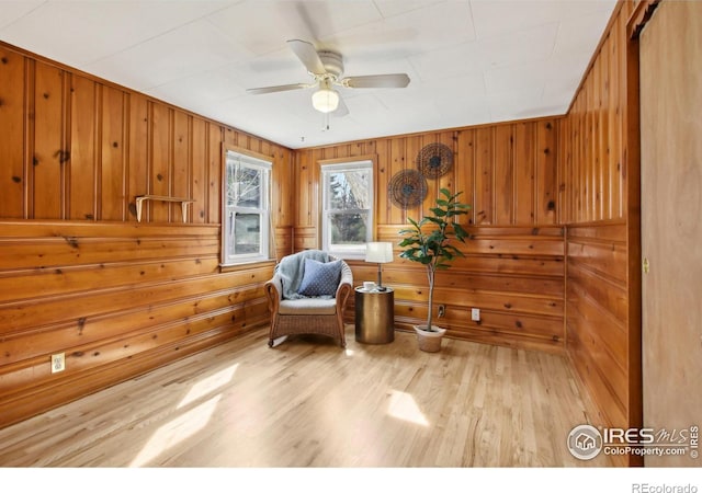 800 W 10th St, Loveland, CO 80537 - sitting room featuring wood finished floors, ceiling fan, and wooden walls